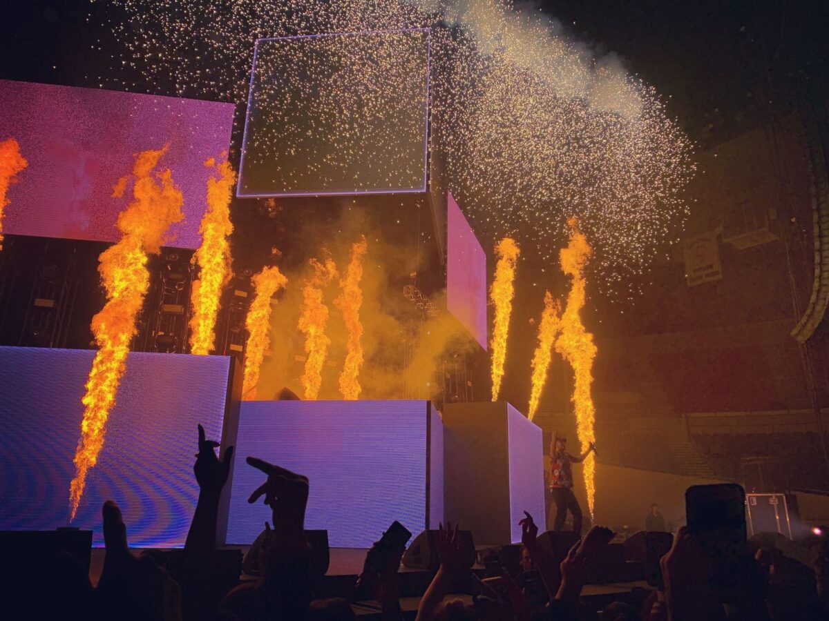 Concert stage with bursts of fire and confetti